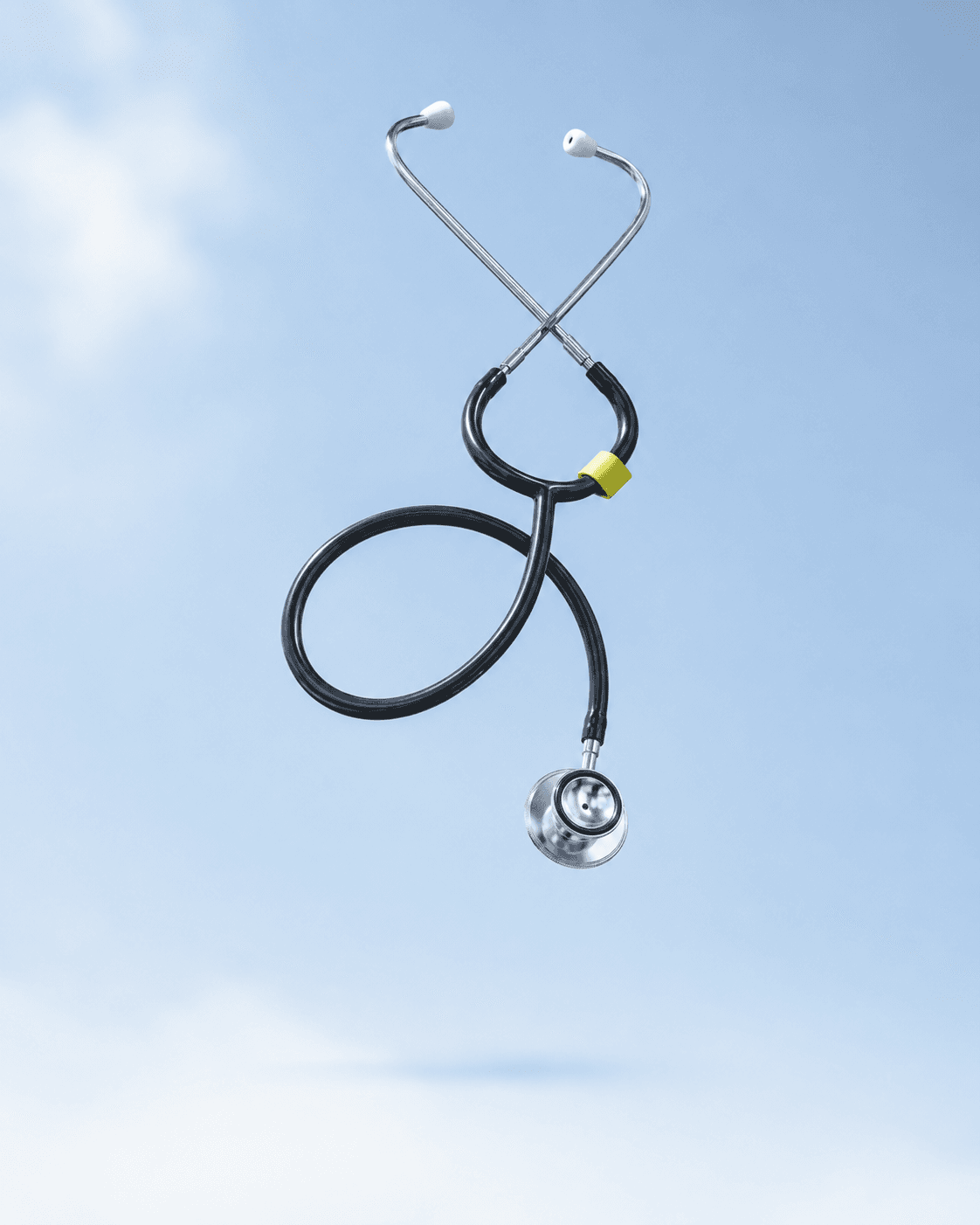 Stethoscope suspended against a pale blue background