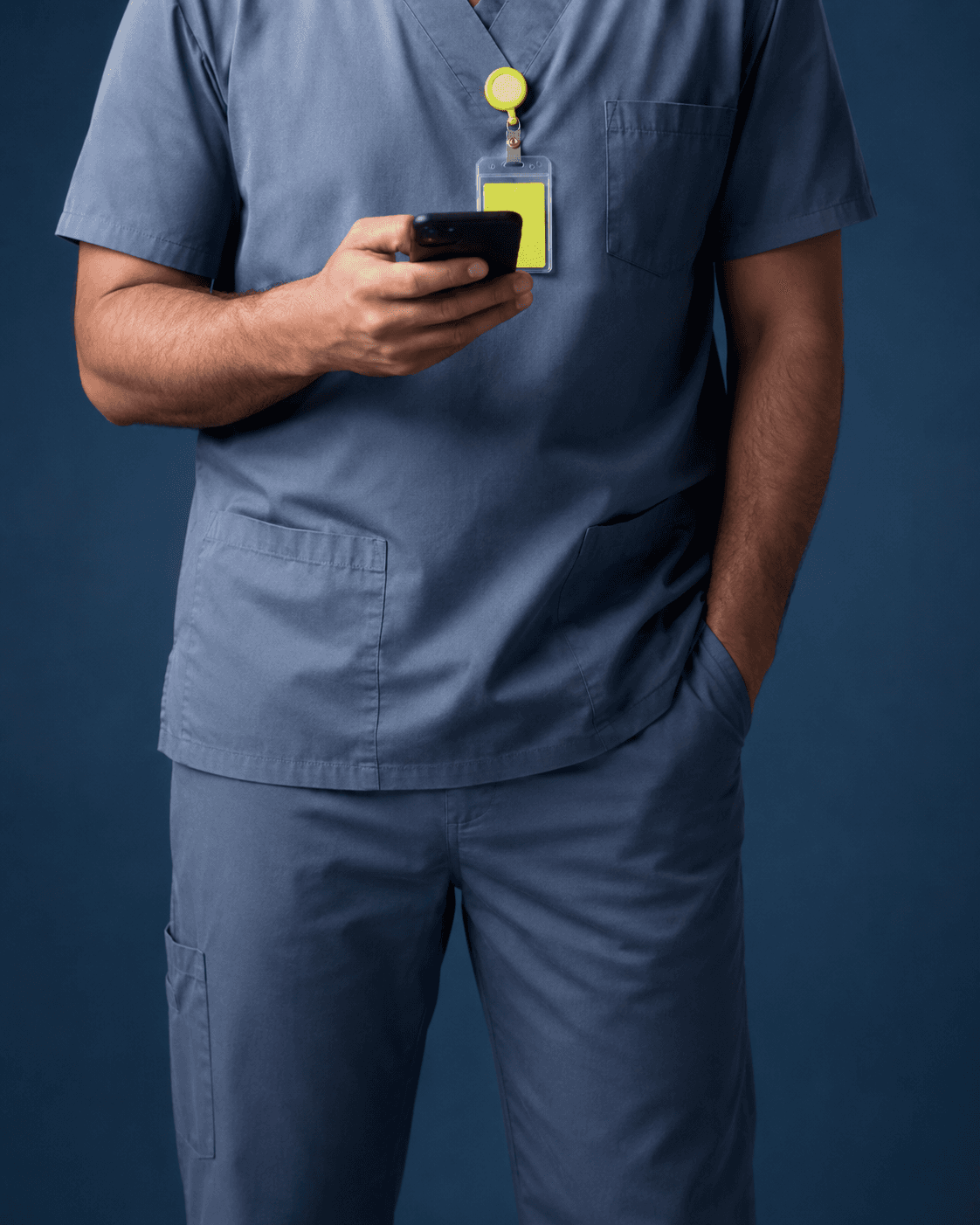 Healthcare professional in scrubs checking a phone